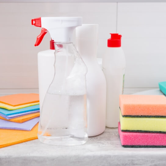 Spray bottle with cleaning liquids and colored sponges