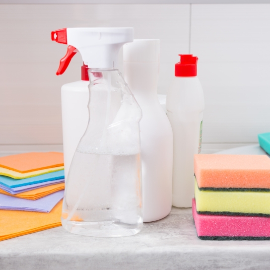 Spray bottle with cleaning liquids and colored sponges